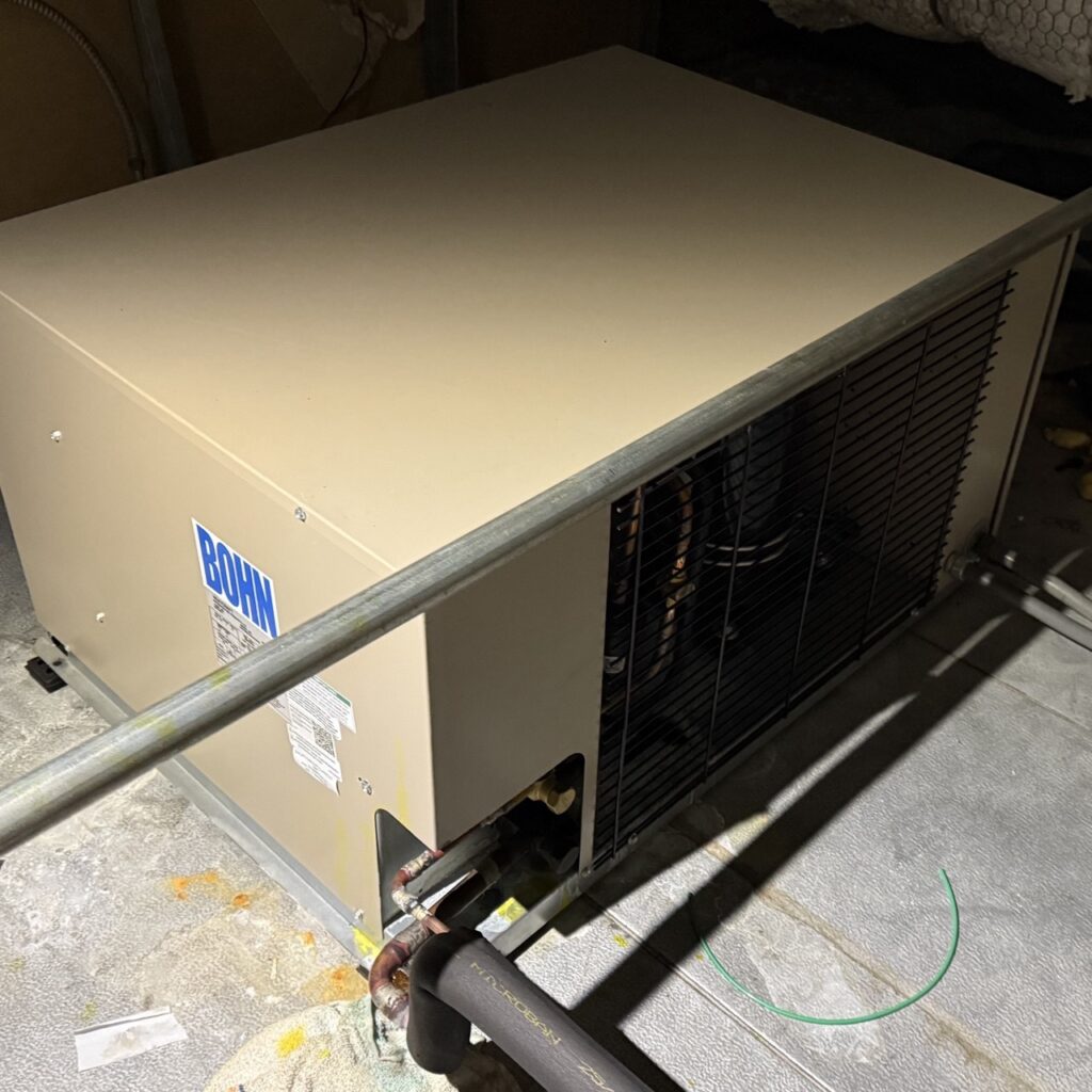 commercial refrigeration repairs 4 Commercial refrigerator condensing unit installed indoors with visible piping and ventilation, illustrating professional commercial refrigerator repair services.