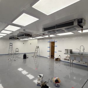 Indoor workspace with ceiling-mounted systems during commercial HVAC repair and installation.