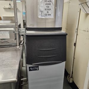 Technician inspecting a commercial ice maker in Everett business kitchen