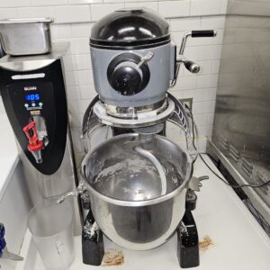 Technician repairing commercial dough mixer in Everett bakery kitchen