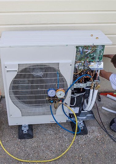 a A/C Dr. Naz technician performs air conditioning repairs in seattle