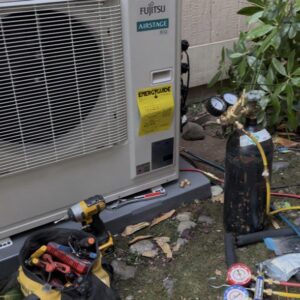 A/C Services professional is pumping high-pressure gas to ensure the system does not have any gas leaks