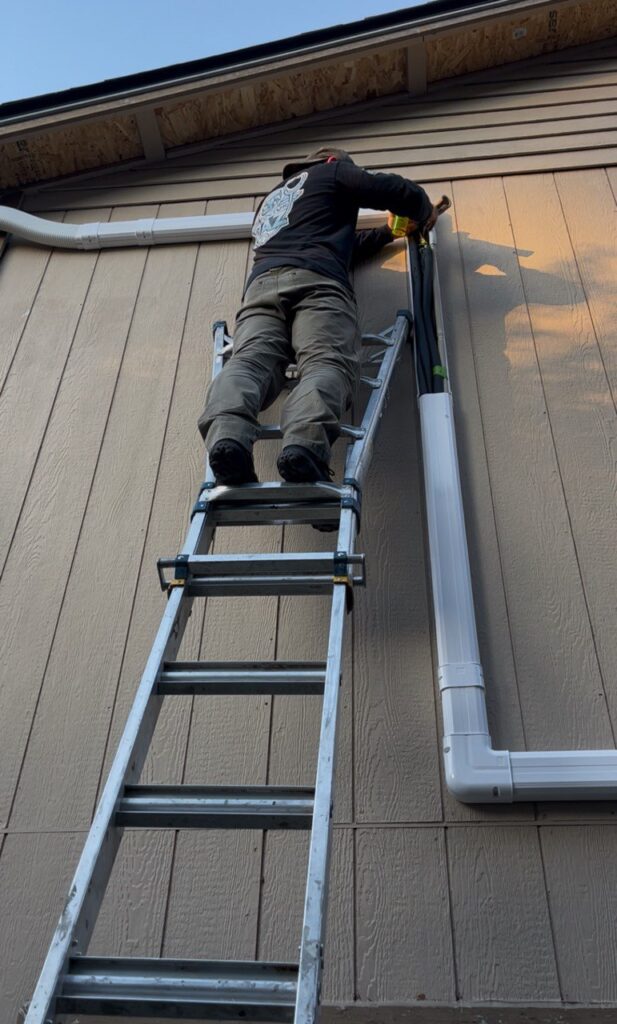 A/C Dr. Naz tech is doing Air conditioning services in seattle, Applying leak detector liquid on pipe joints.