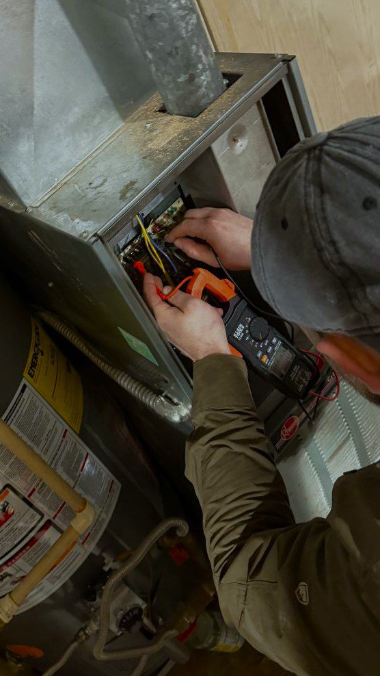 Gas Furnace Repair Everett, WA a Technician is checking the furnace wires by multimeter