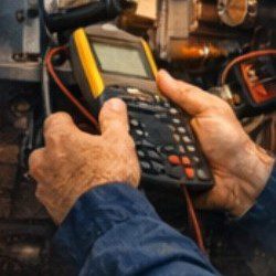 a digital testing tool in technician hands while providing heating services diagnstic to a customer in Gold Bar, WA, in Snohomish County, USA