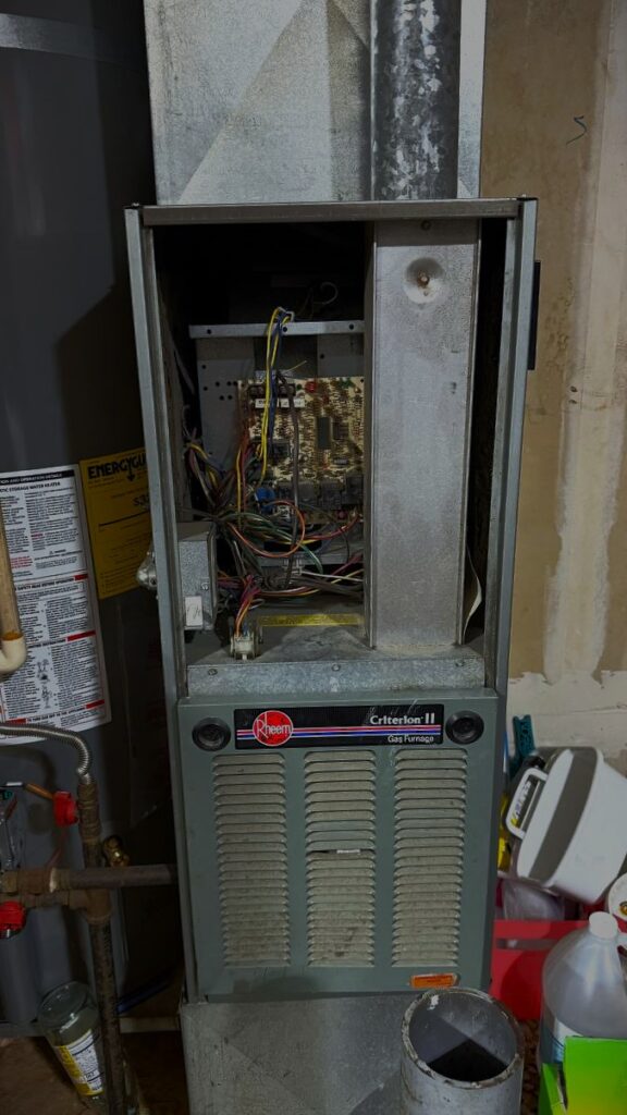 Furnace repair professional filling out a digital service report on a tablet after successfully restoring heat to an Everett residence.