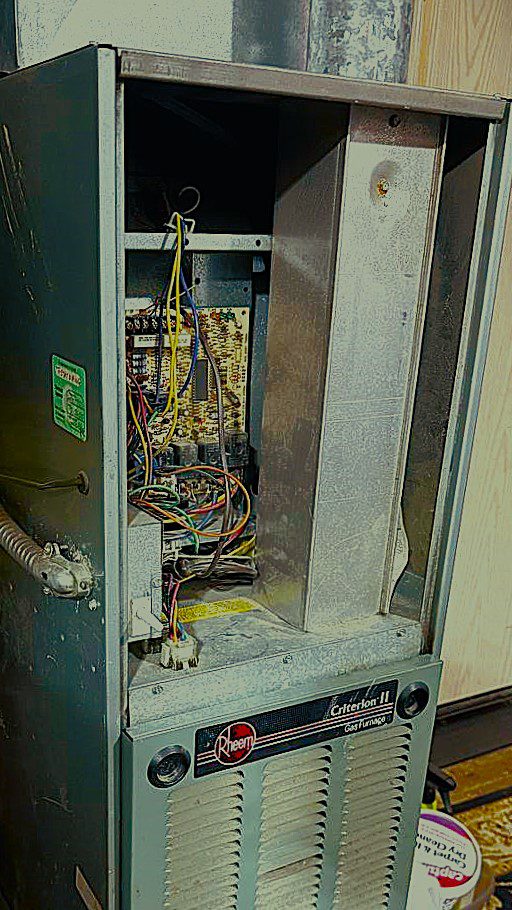 Close-up of a heating technician inspecting the blue flame of a gas furnace burner to ensure safe and efficient operation in Everett, WA.