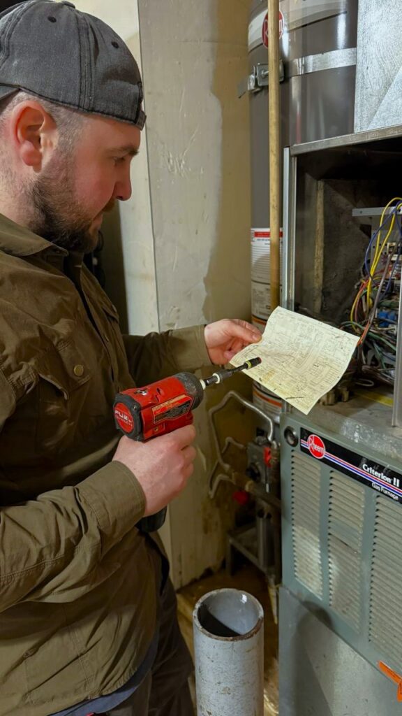 A/C Dr. Naz technician checking gas pressure levels on a residential furnace.