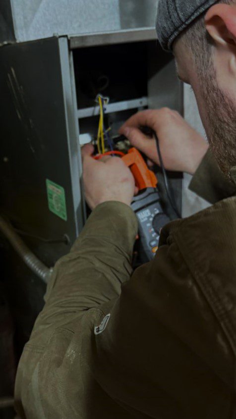 Licensed HVAC technician performing a safety diagnostic on a gas furnace in Everett.