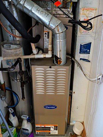 Clean, vertical gas furnace installation featuring a high-efficiency media air cleaner.