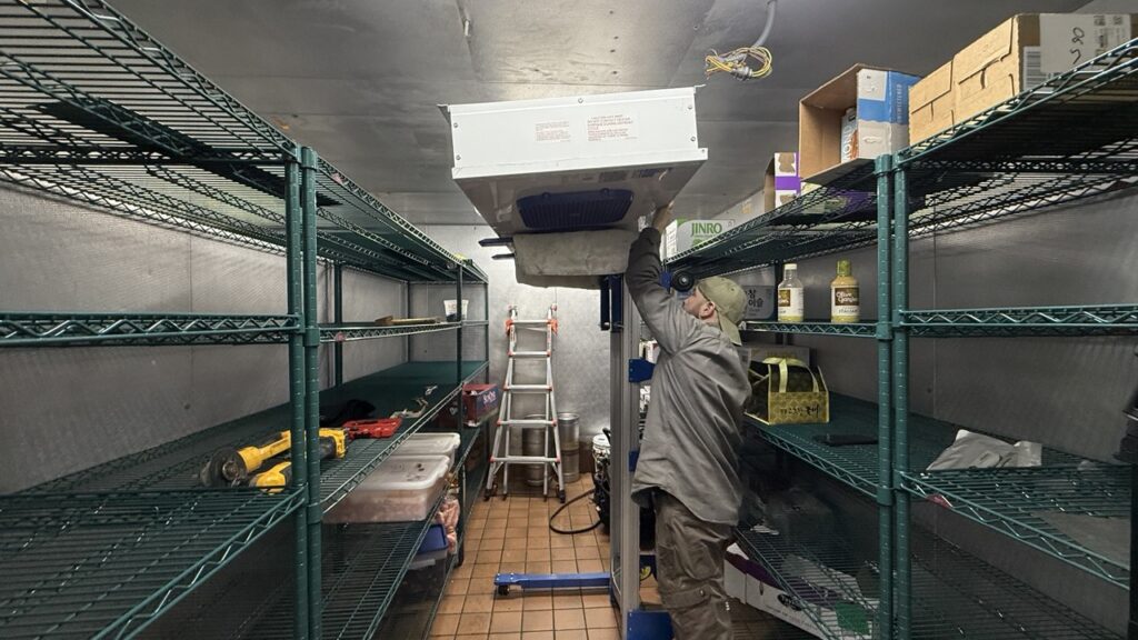 Technician is working on walk in cooler repairs. Evaporator Coil Repair process in particular