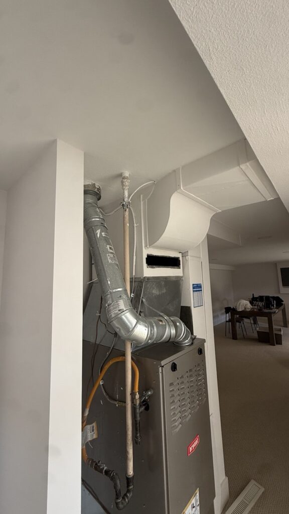 A steady blue pilot light flame indicating a safe and efficient gas furnace after professional repair.