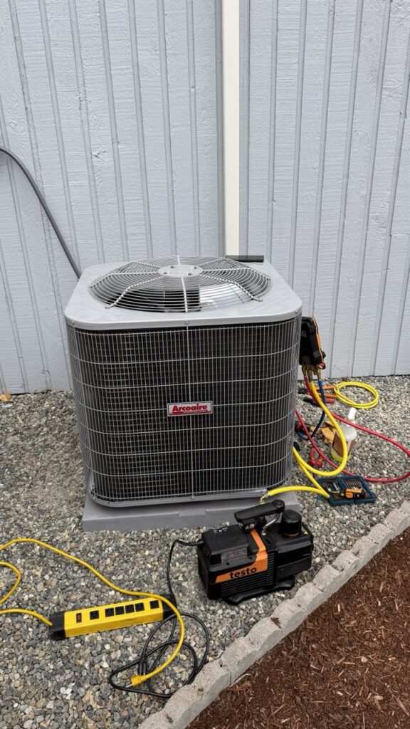 Modern air-source heat pump connected to a residential furnace system for a dual-fuel heating solution in Marysville.