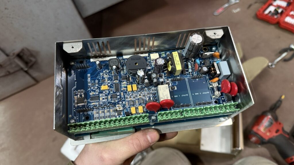 Convection oven "brain" is in technician hands during the repair process in a bakery