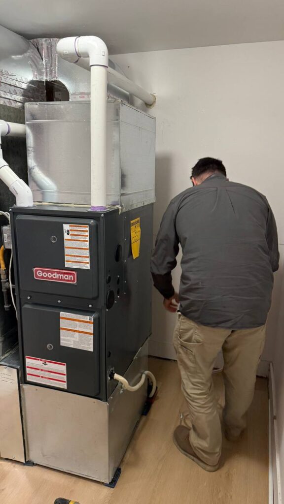 Another perspective of A/C Dr. Naz technician is diagnosting High efficiency 96% gas furnace providing heating services to seattle homeowner