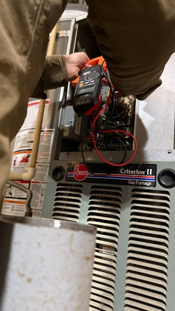 HVAC technician from A/C Dr. Naz performing gas furnace diagnostic during heating service in Marysville, WA