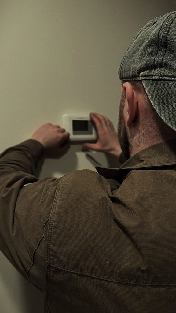 Completed furnace repair showing technician confirming proper operation