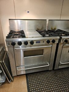 Commercial gas range during preventative maintenance in a Puget Sound restaurant kitchen