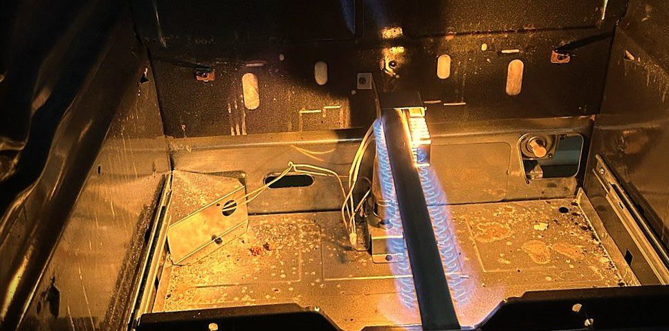 Inside of commercial Gas range during process of repair