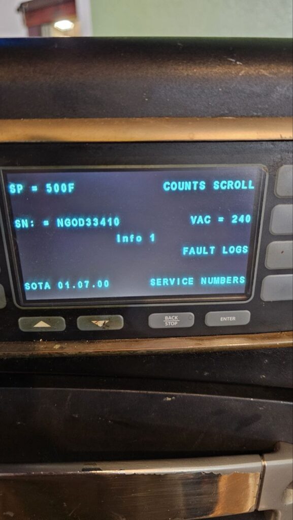 Before: Front view of a non-functional Merrychef turbo oven in a professional kitchen before diagnostic testing.