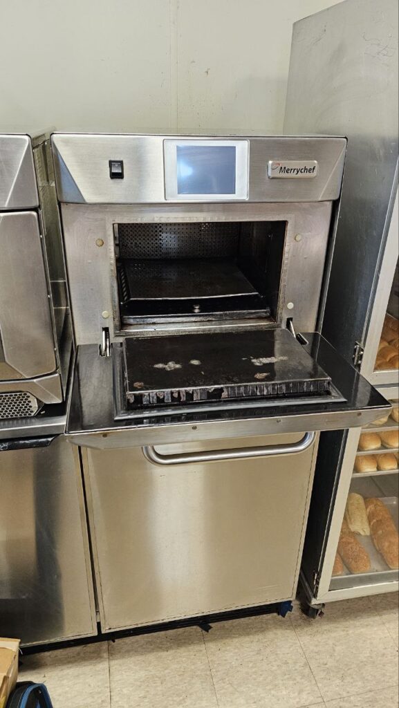 Interior view of a commercial convection turbo oven with heavy carbon buildup before deep cleaning and maintenance.