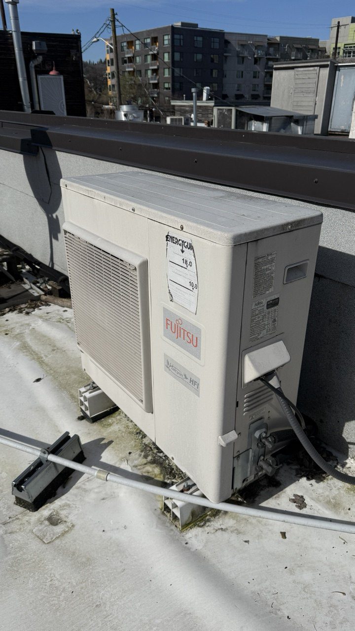 Fujitsu Halcyon HFI commercial multi-zone heat pump system being serviced on a multi-tenant building rooftop in Seattle by A/C Dr. Naz.