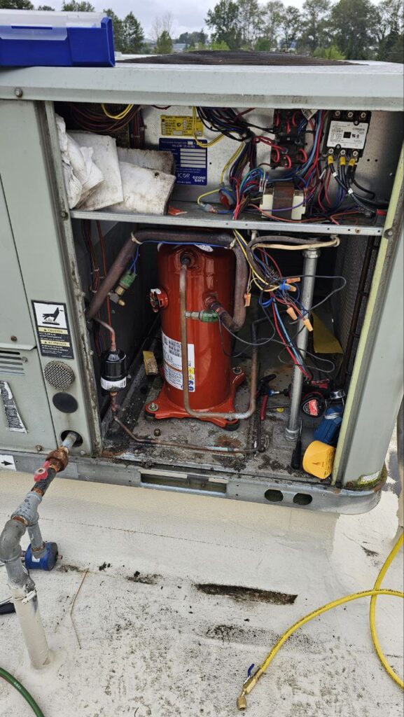 A close-up of a CPS digital micron gauge attached to a Yellow Jacket manifold gauge set. The screen displays a precise reading of 490 microns, demonstrating that the HVAC system has been successfully evacuated of moisture and non-condensables.