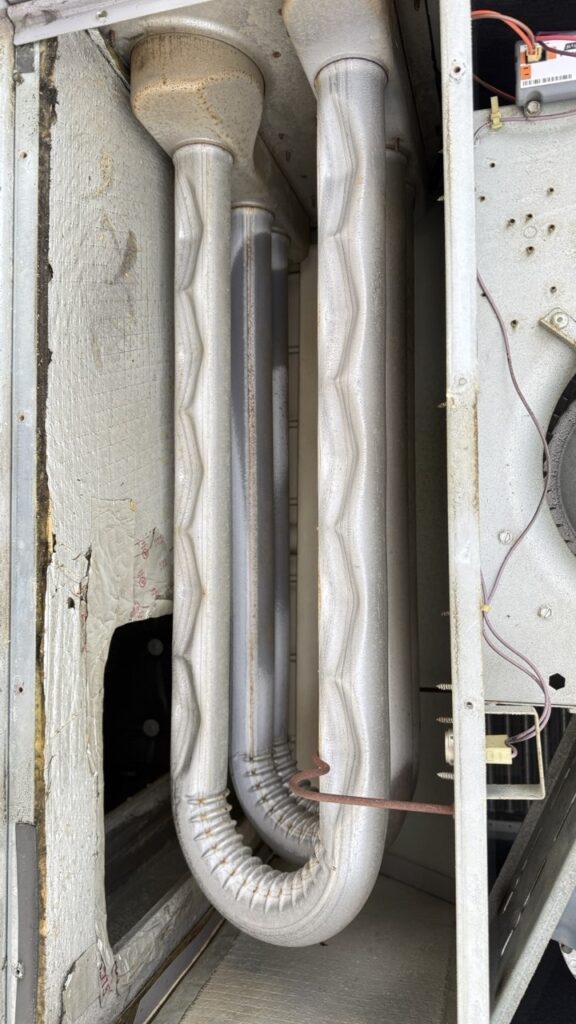 High-precision inspection of a commercial furnace heat exchanger during a routine maintenance service in Seattle to ensure no cracks or safety hazards.