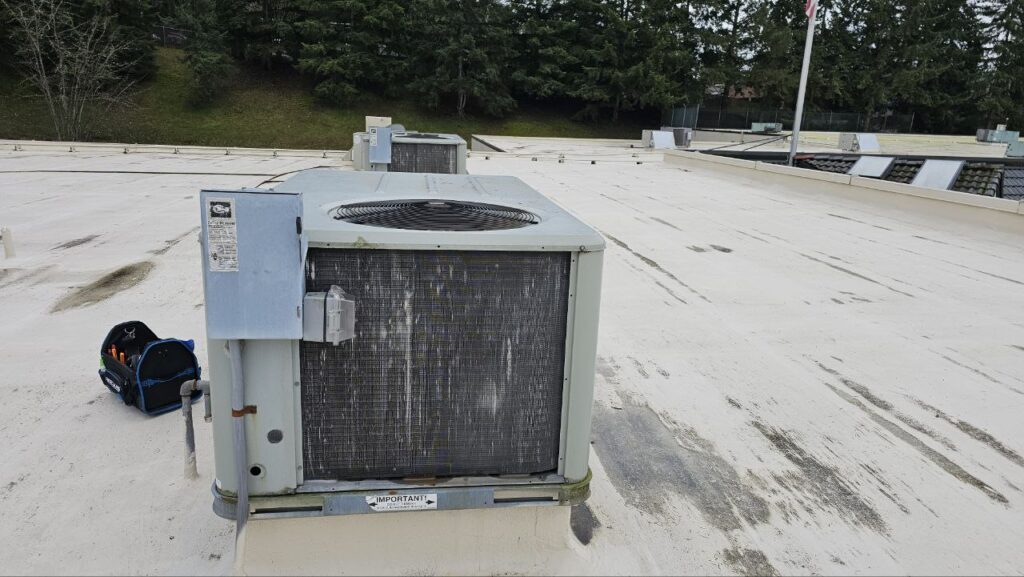 Inspecting rusted heat exchanger tubes for structural integrity during a commercial furnace maintenance check in Seattle.