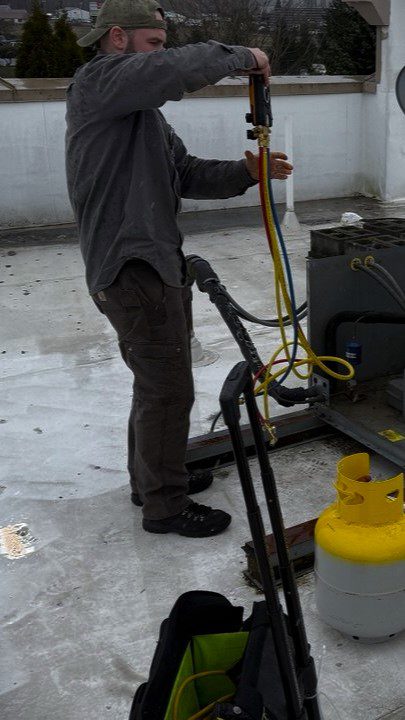 HVAC/R certified specialist and the founder of A/C Dr. Naz is working on walk in cooler repair in port facility at Everett, WA waterfront