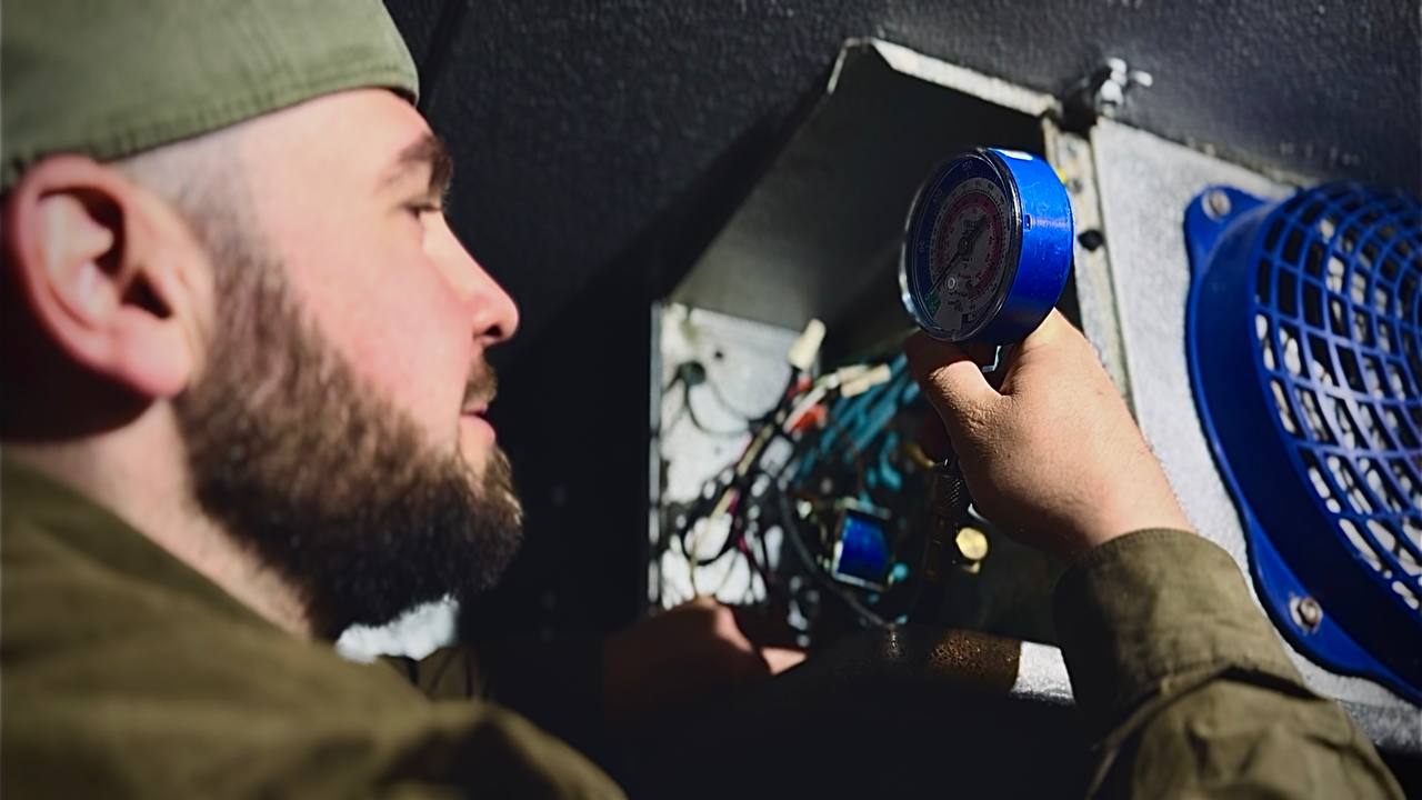 A/C Dr. Naz technician checking gauges and sequence of operation on commercial refrigeration equipment