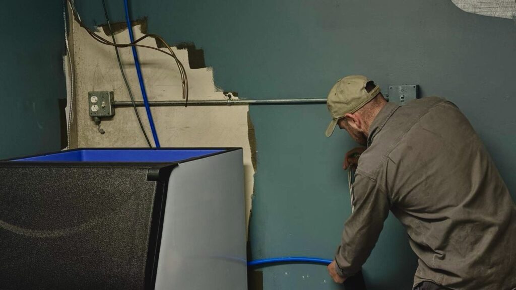 Technician diagnosing commercial ice machine refrigeration at Marysville fuel stop
