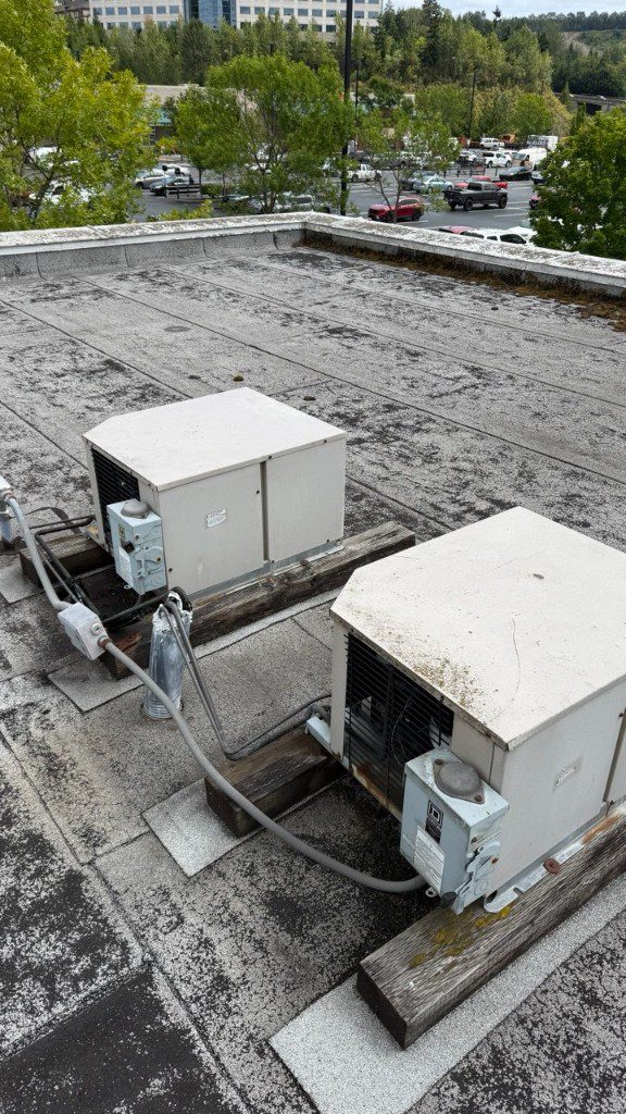 Manifold gauges on kitchen floor during commercial refrigeration service