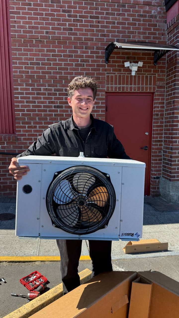 Technician with a replacement commercial refrigeration evaporator unit — A/C Dr. Naz