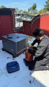 Technician servicing rooftop refrigeration
