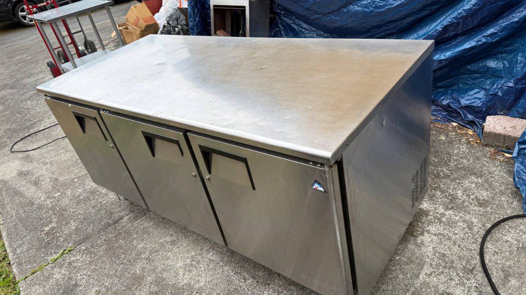 Field photo of a three-door stainless commercial undercounter refrigerator — serves Lake Forest Park, WA commercial refrigeration repair