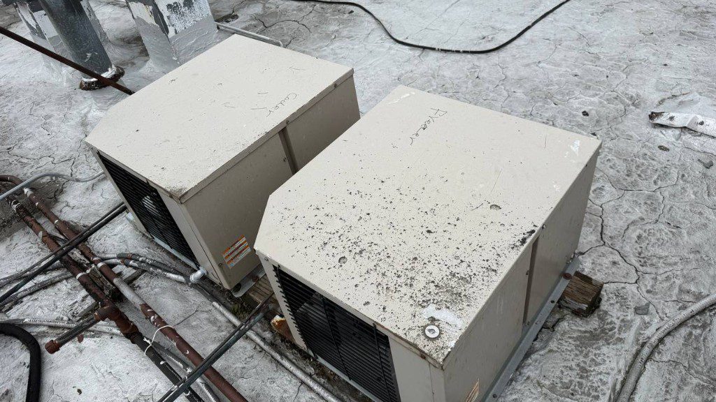 Field photo of rooftop cooler and freezer condensers labeled by hand — serves Duvall, WA commercial refrigeration repair