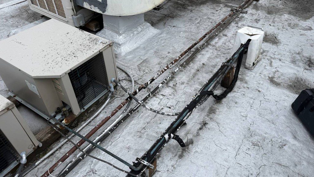 Field photo of commercial freezer condenser and linesets on a roof — serves Duvall, WA commercial refrigeration repair