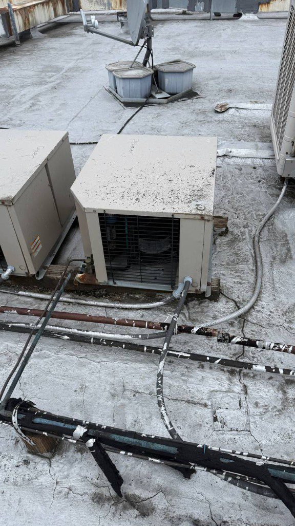Field photo of rooftop cooler and freezer condensers with piping and conduits — serves Sultan, WA commercial refrigeration repair