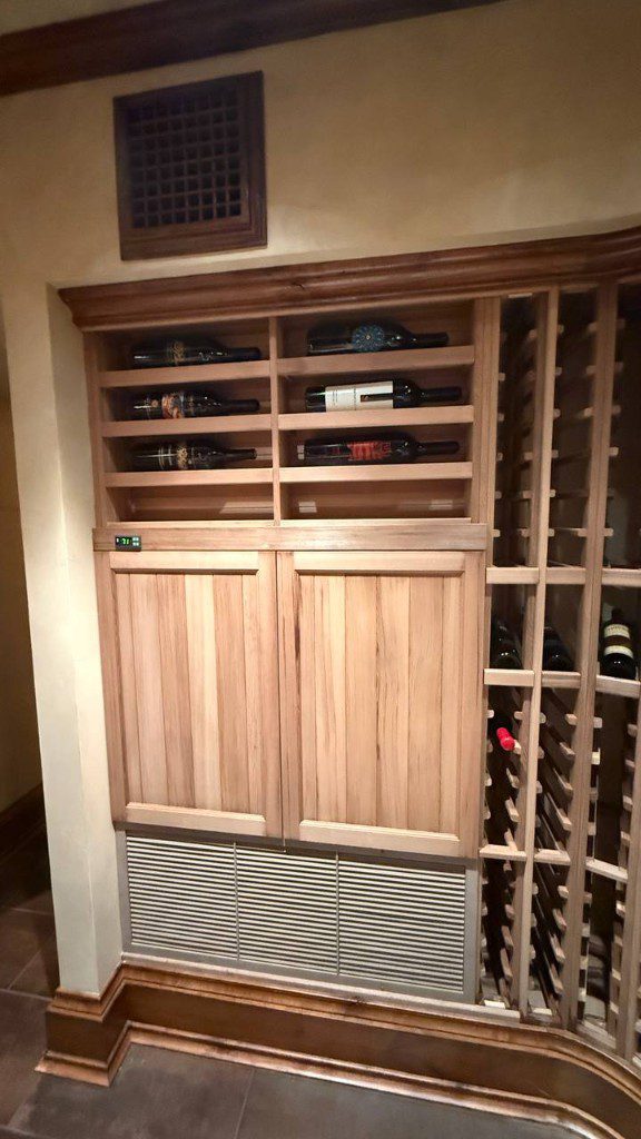 Field photo of wine cellar cabinetry with integrated digital temperature display — serves Issaquah, WA commercial refrigeration repair
