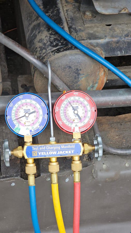 Technician checking pressures on a commercial circuit