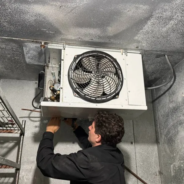 A/C Dr. Naz technician servicing a commercial walk-in cooler in Greater Seattle.
