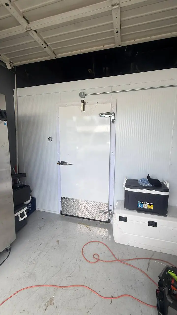 Technician checking evaporator and controls on a medium-temp box — A/C Dr. Naz