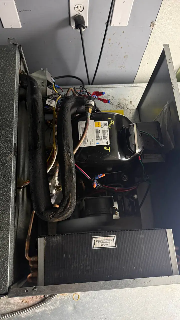 Walk-in freezer ceiling ice and frost at a conduit penetration — service