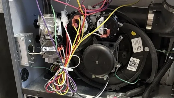 Gas valve, wiring, and inducer motor inside a furnace cabinet